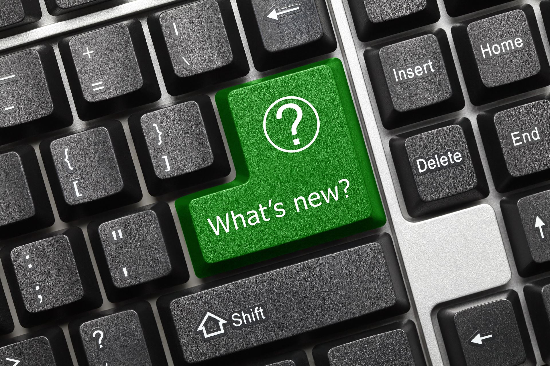 keyboard with a green shift key that says what's new