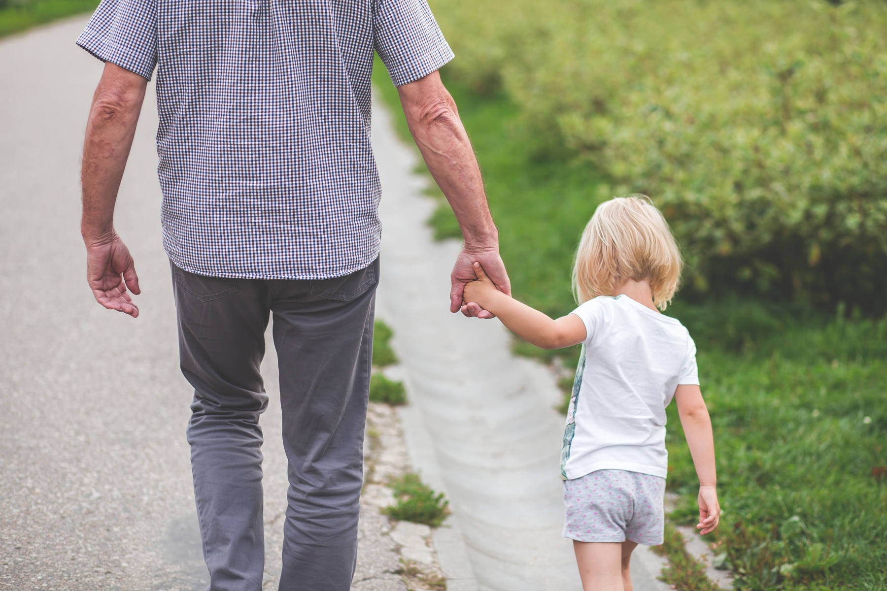 father holding daughters hand